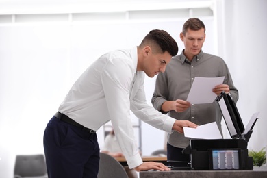 Photo of Employee using new modern printer in office