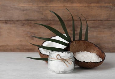 Photo of Composition with natural organic coconut oil on table. Space for text