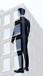 Double exposure of businessman and office building