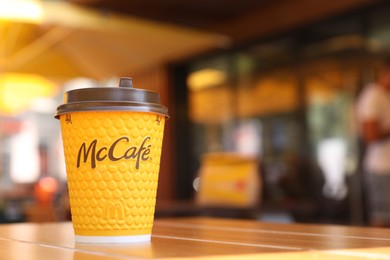 MYKOLAIV, UKRAINE - AUGUST 11, 2021: Hot McDonald's drink on table in cafe. Space for text