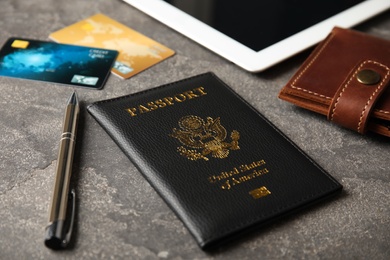 Composition with passport and wallet on grey table. Travel agency