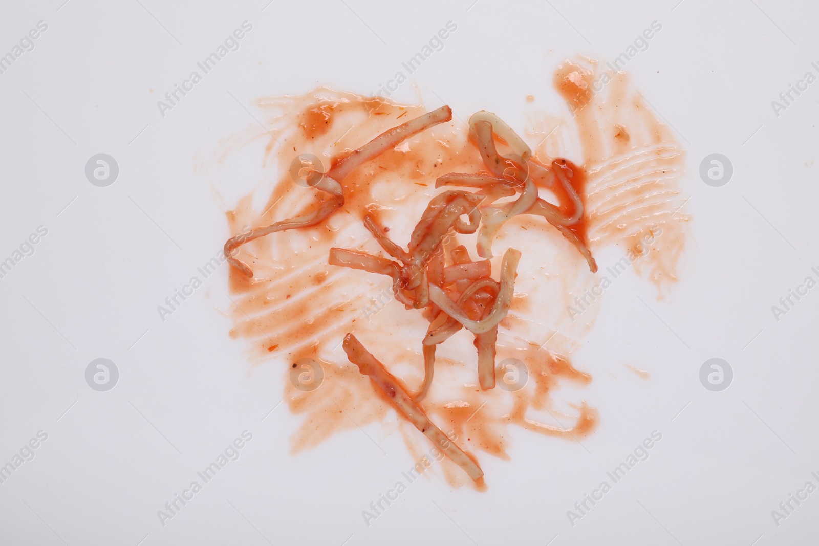 Photo of Smear of sauce and pasta on white background, top view