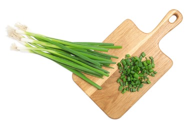 Photo of Wooden board with green spring onions on white background, top view