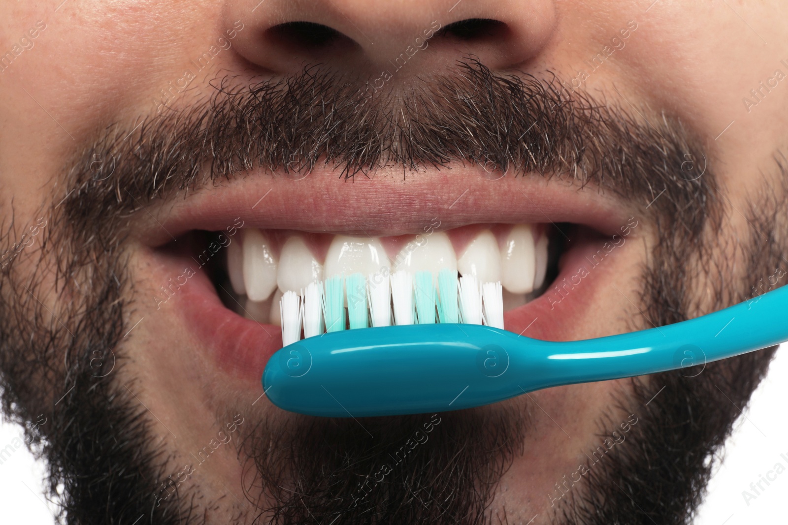 Photo of Man brushing teeth on white background, closeup. Dental care