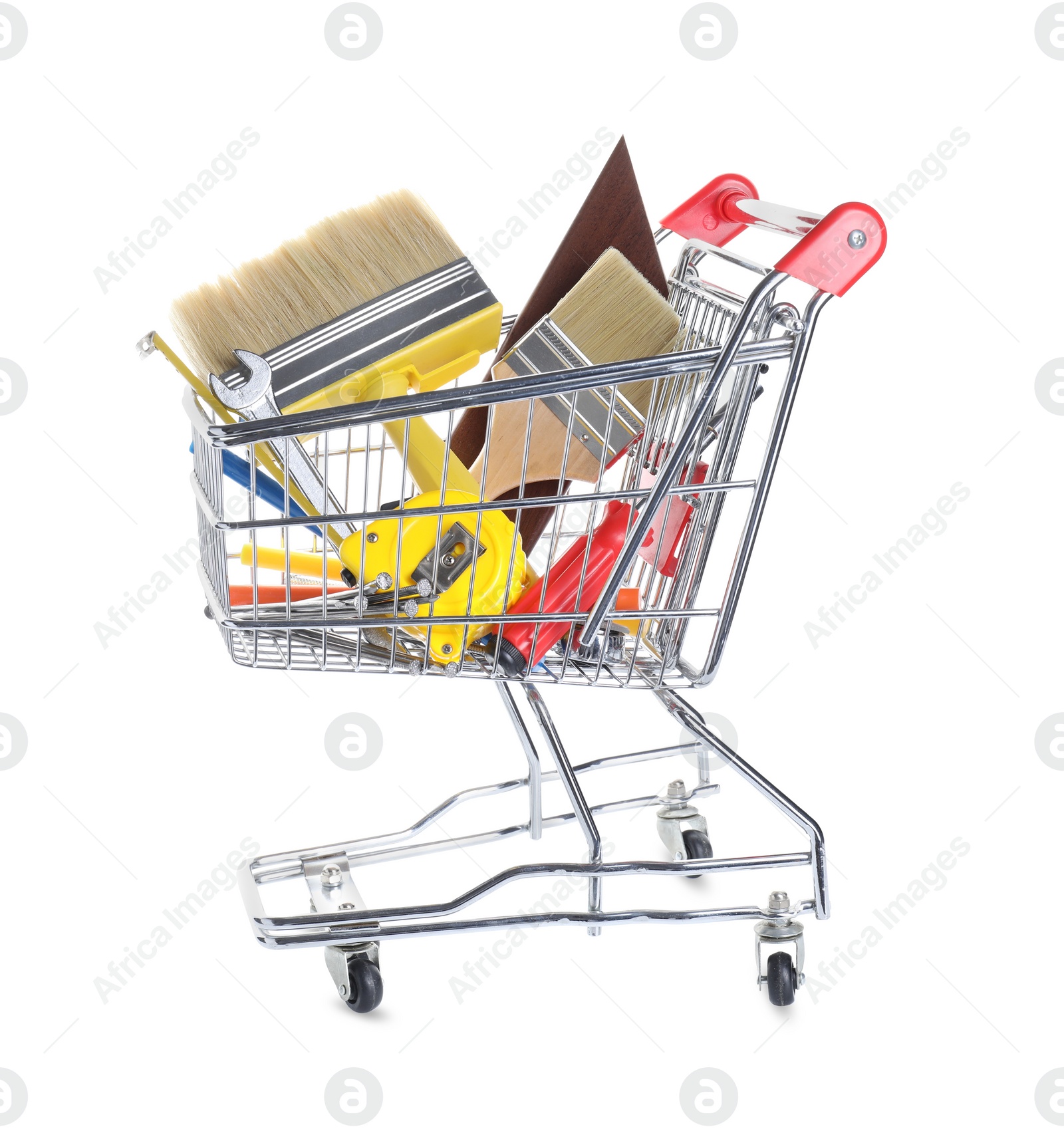 Photo of Different construction tools in shopping cart isolated on white