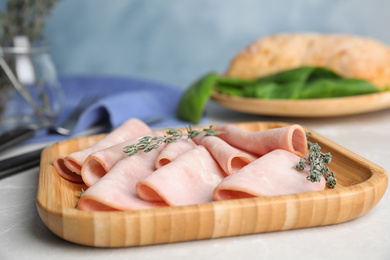 Tasty fresh ham on light grey marble table, closeup