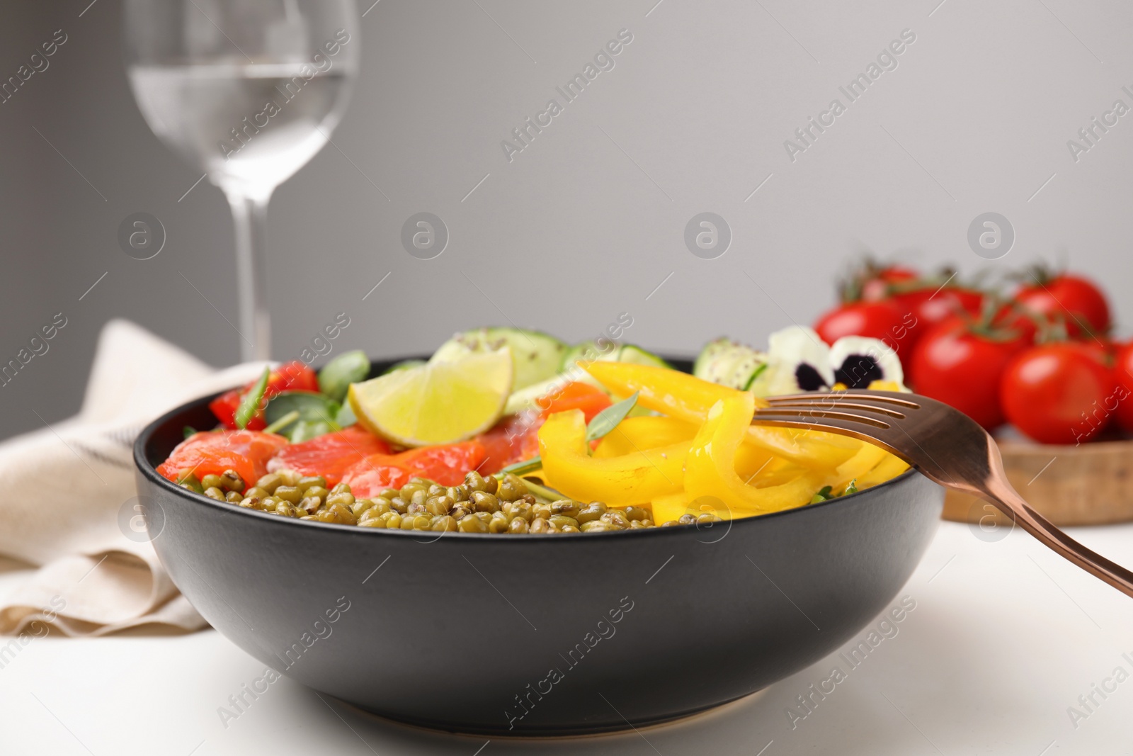 Photo of Bowl of salad with mung beans on white table