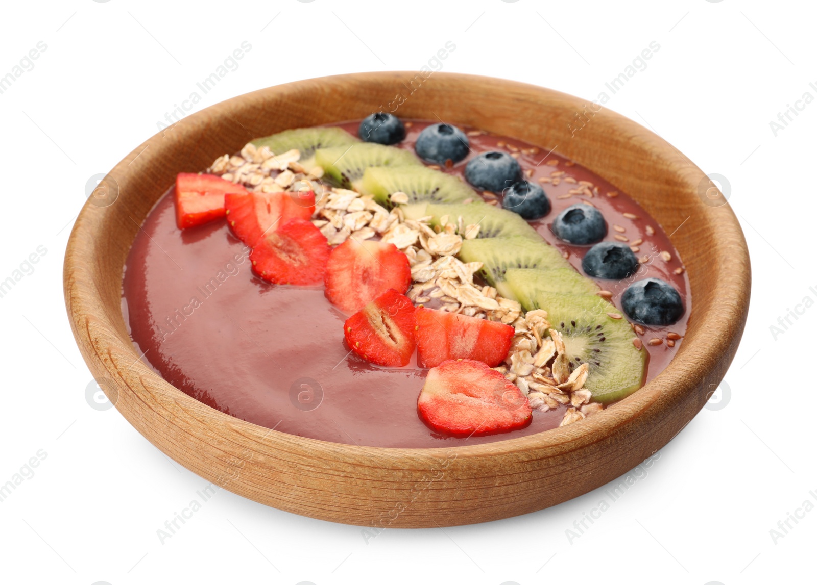 Photo of Bowl of delicious smoothie with fresh blueberries, strawberries, kiwi slices and oatmeal on white background