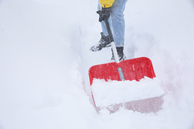 Man cleaning snow with shovel outdoors, closeup