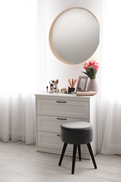 Stylish room interior with dressing table and mirror