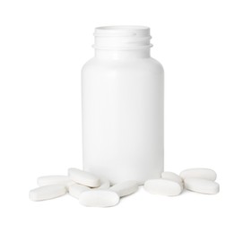 Bottle and pile of vitamin pills isolated on white