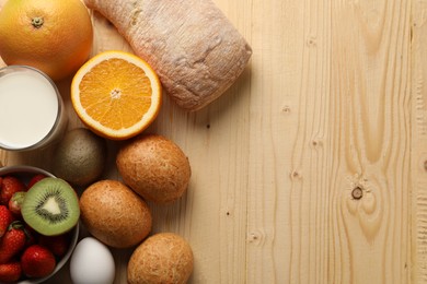 Allergenic food. Different fresh products on wooden table, flat lay and space for text