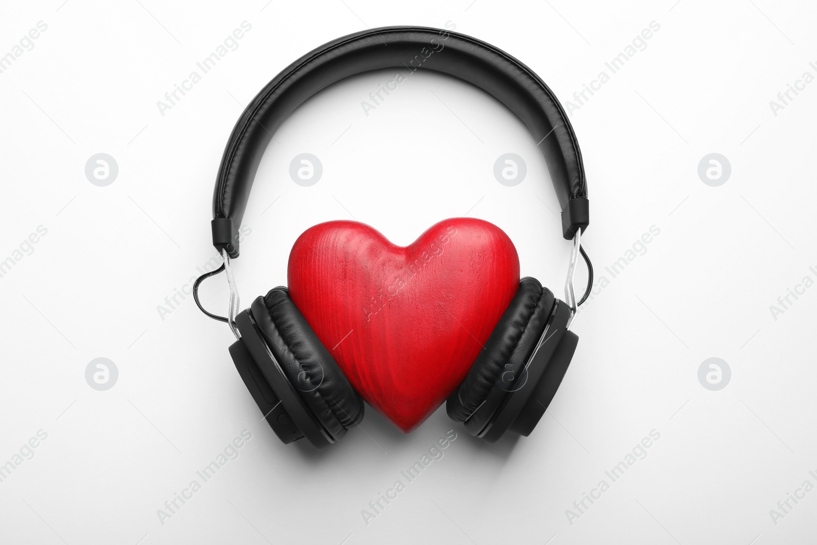 Photo of Decorative heart and modern headphones on white background, top view