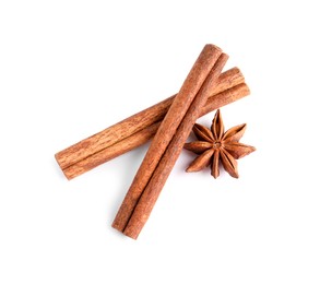 Photo of Cinnamon sticks and anise star isolated on white, top view