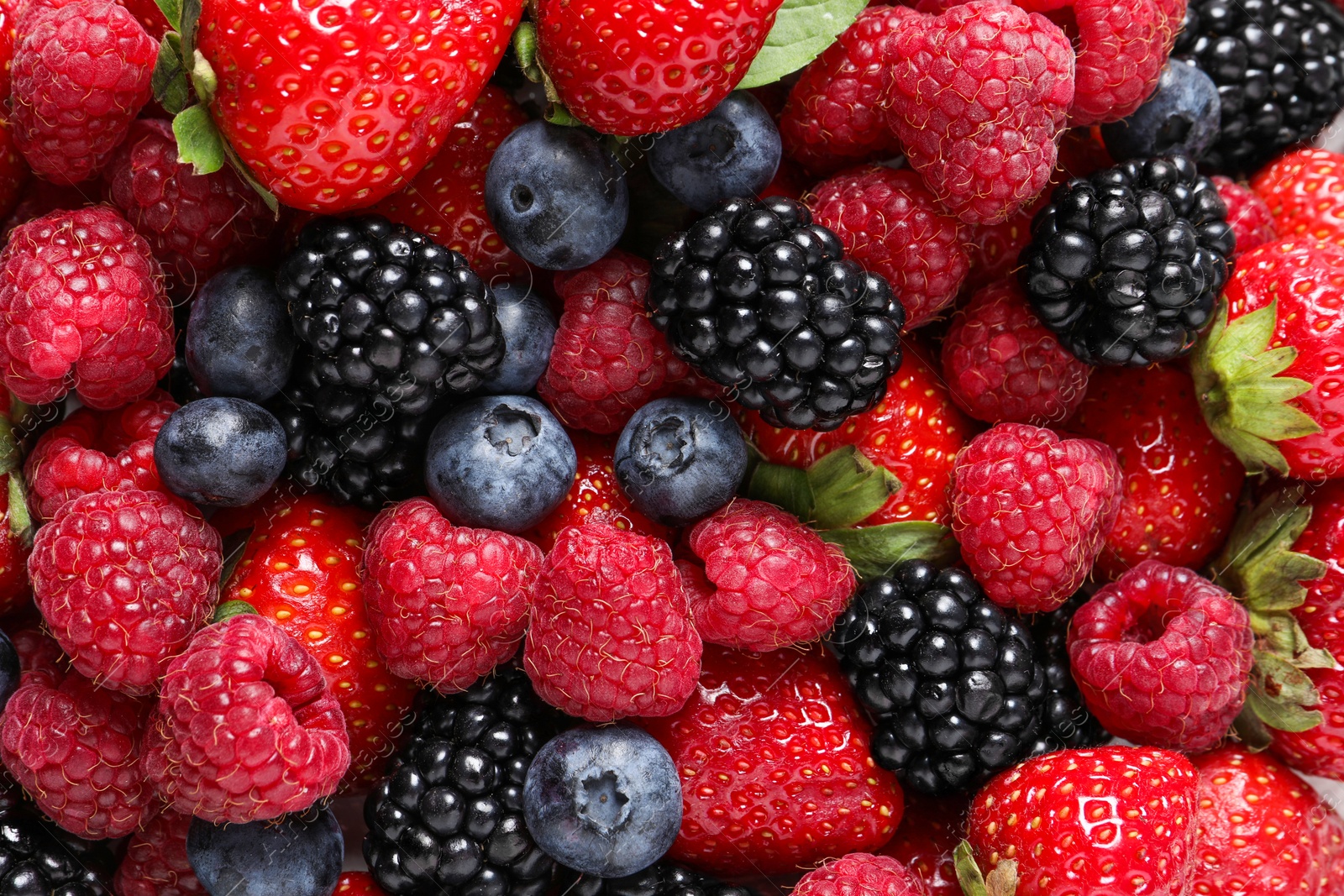 Photo of Different fresh ripe berries as background, top view