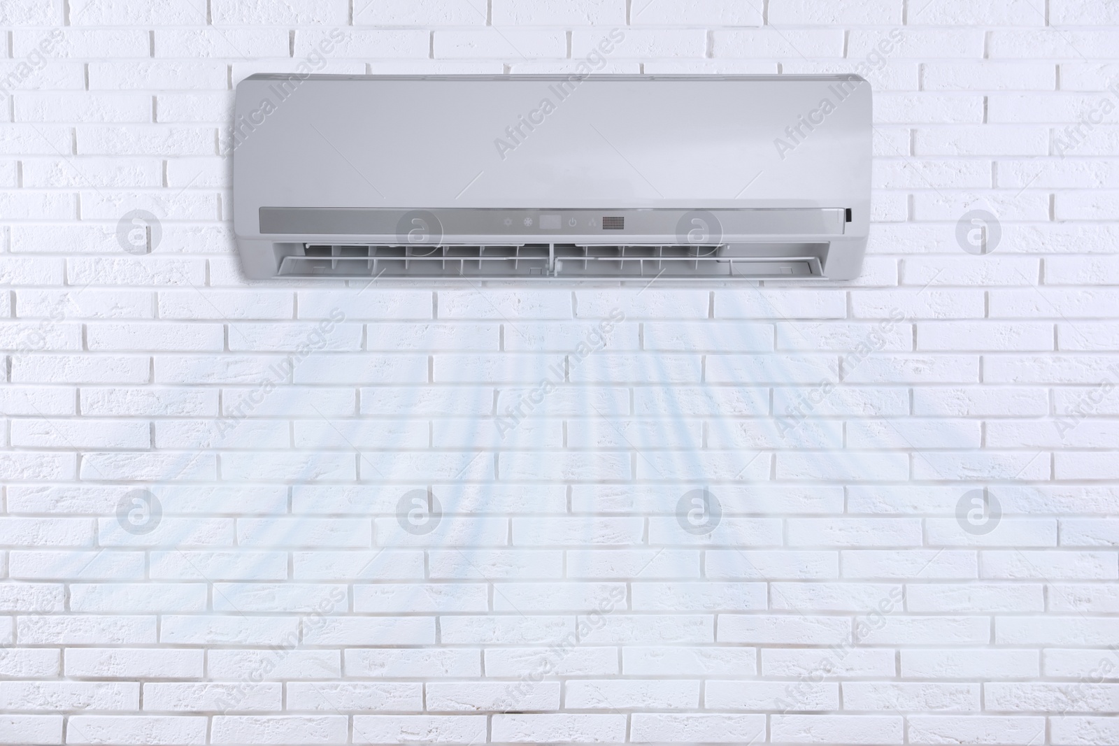 Image of Modern air conditioner on white brick wall indoors