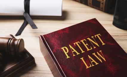 Image of Patent Law book on wooden table, closeup 