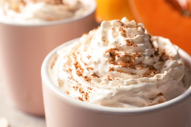 Cup with tasty pumpkin spice latte, closeup