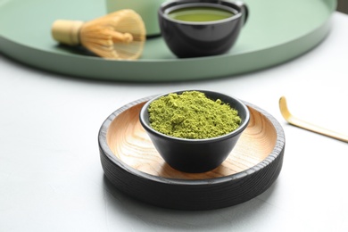 Bowl with powdered matcha tea on table