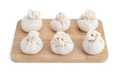 Photo of Wooden board with uncooked khinkali (dumplings) isolated on white. Georgian cuisine