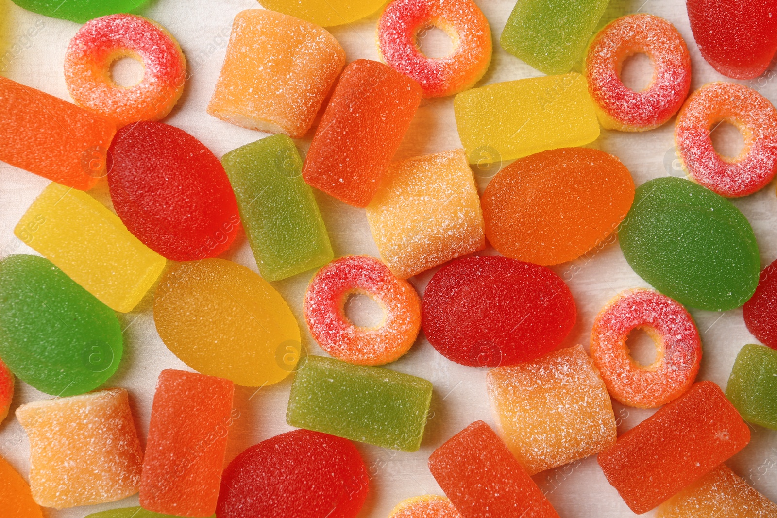 Photo of Flat lay composition with delicious jelly candies on wooden background