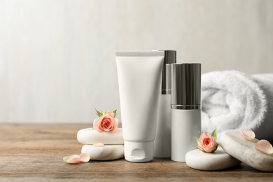 Composition with cosmetic products on wooden table