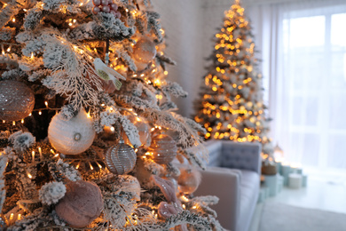 Christmas tree branch with balls indoors, closeup. Festive interior decoration