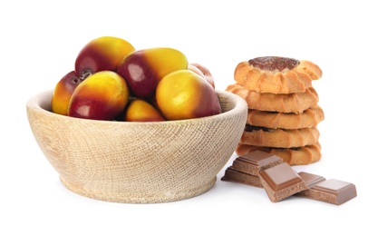 Image of Fresh ripe palm oil fruits and sweets on white background