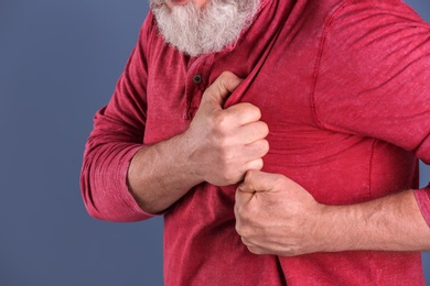 Mature man having heart attack, closeup