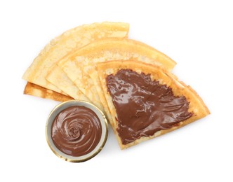 Photo of Tasty crepes with chocolate paste isolated on white, top view