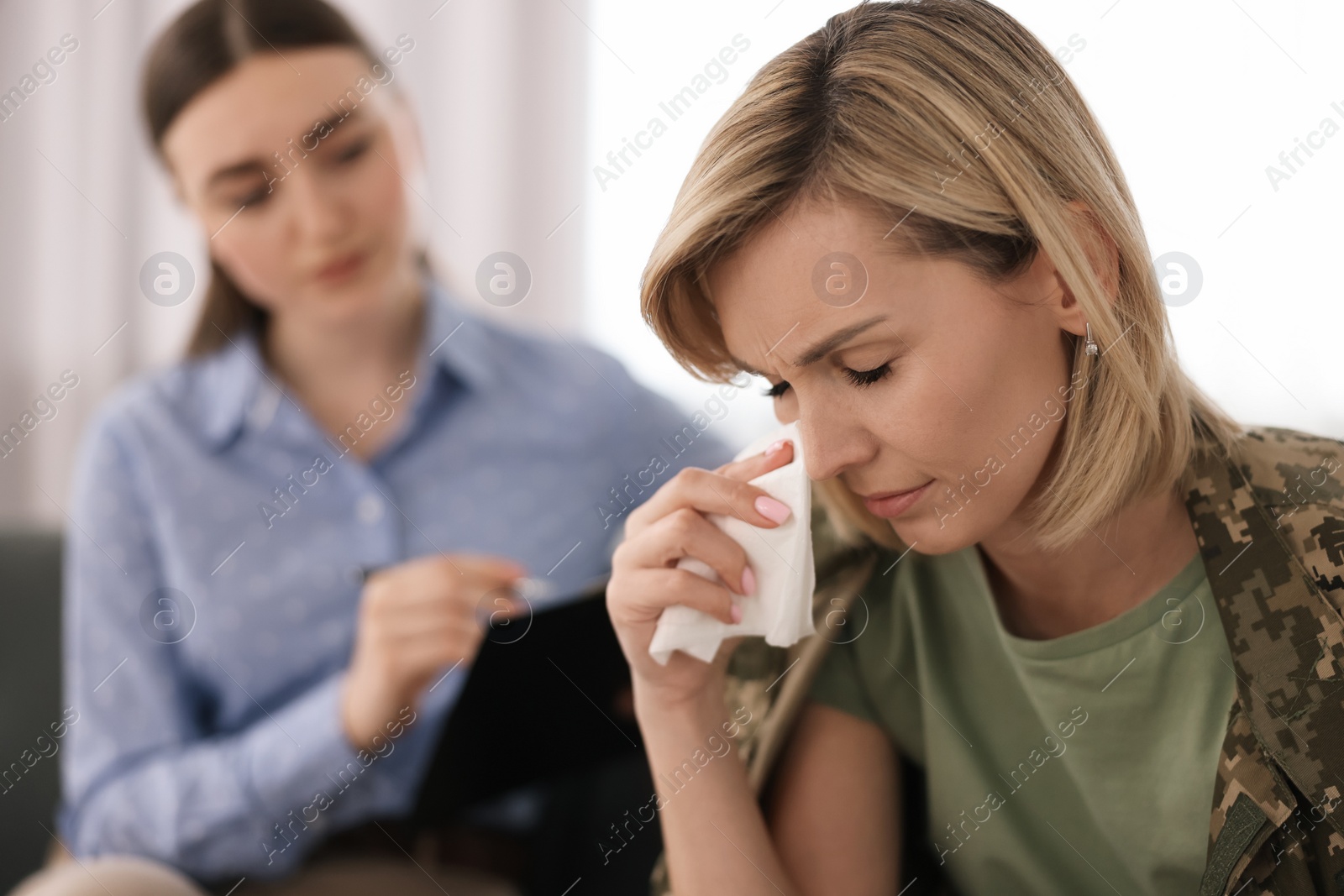 Photo of Psychotherapist working with military woman in office