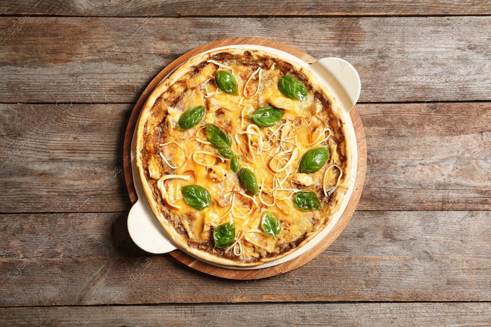 Photo of Board with delicious homemade pizza on wooden background, top view