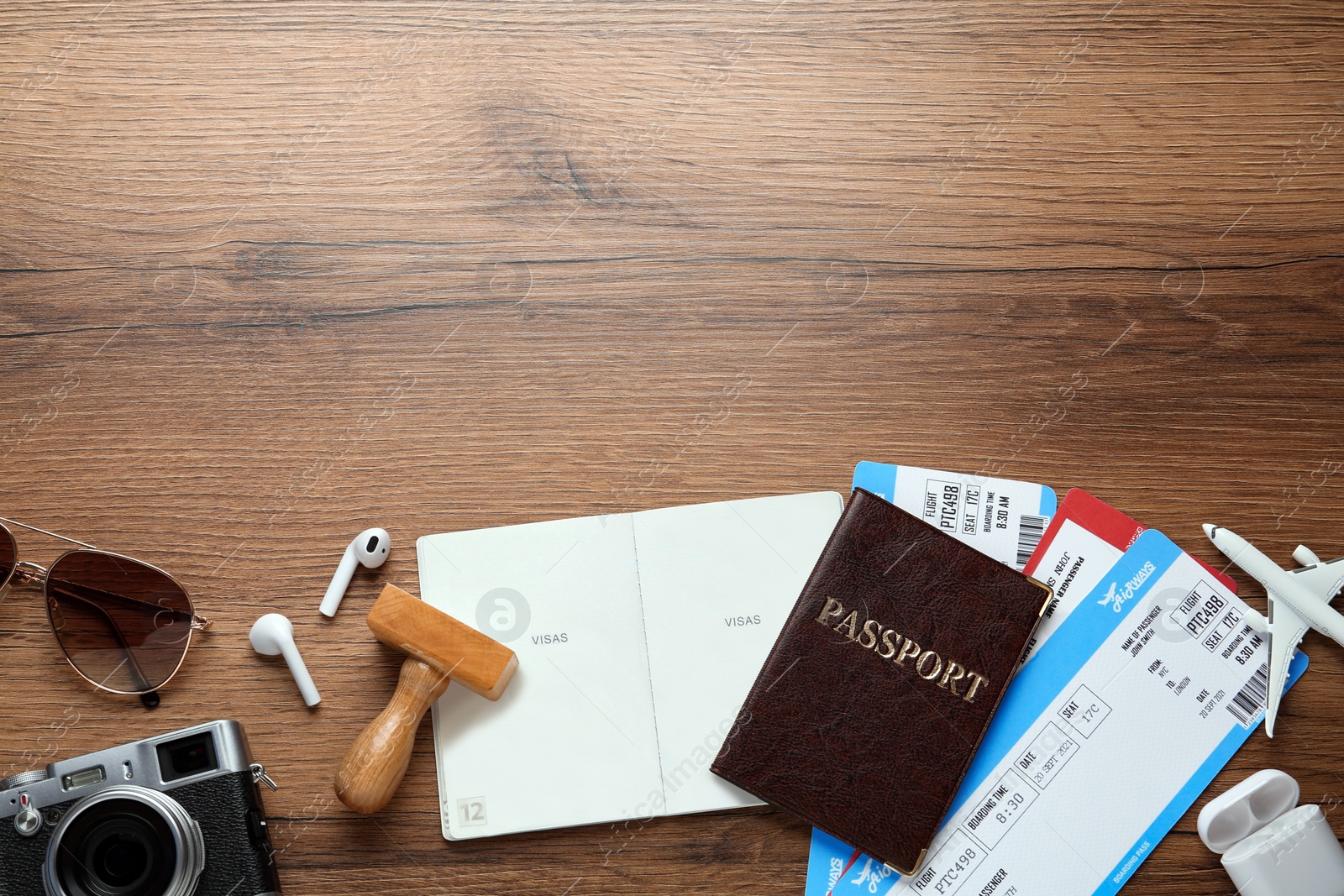 Photo of Flat lay composition with passports, stamp and flight tickets on wooden table, space for text