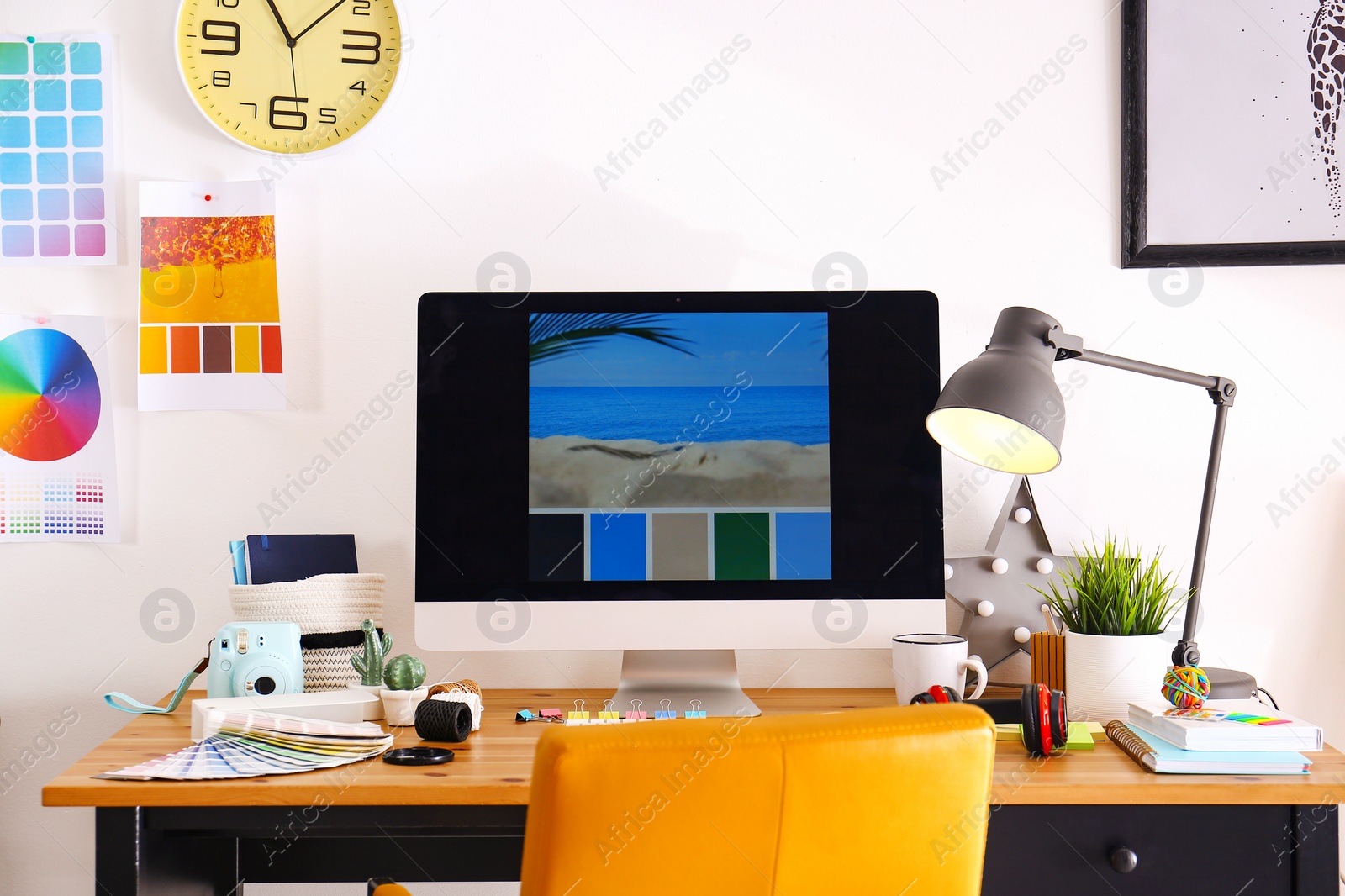 Photo of Comfortable designer's workplace with modern computer in studio