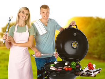 Image of Happy couple cooking on barbecue grill in park. Picnic time