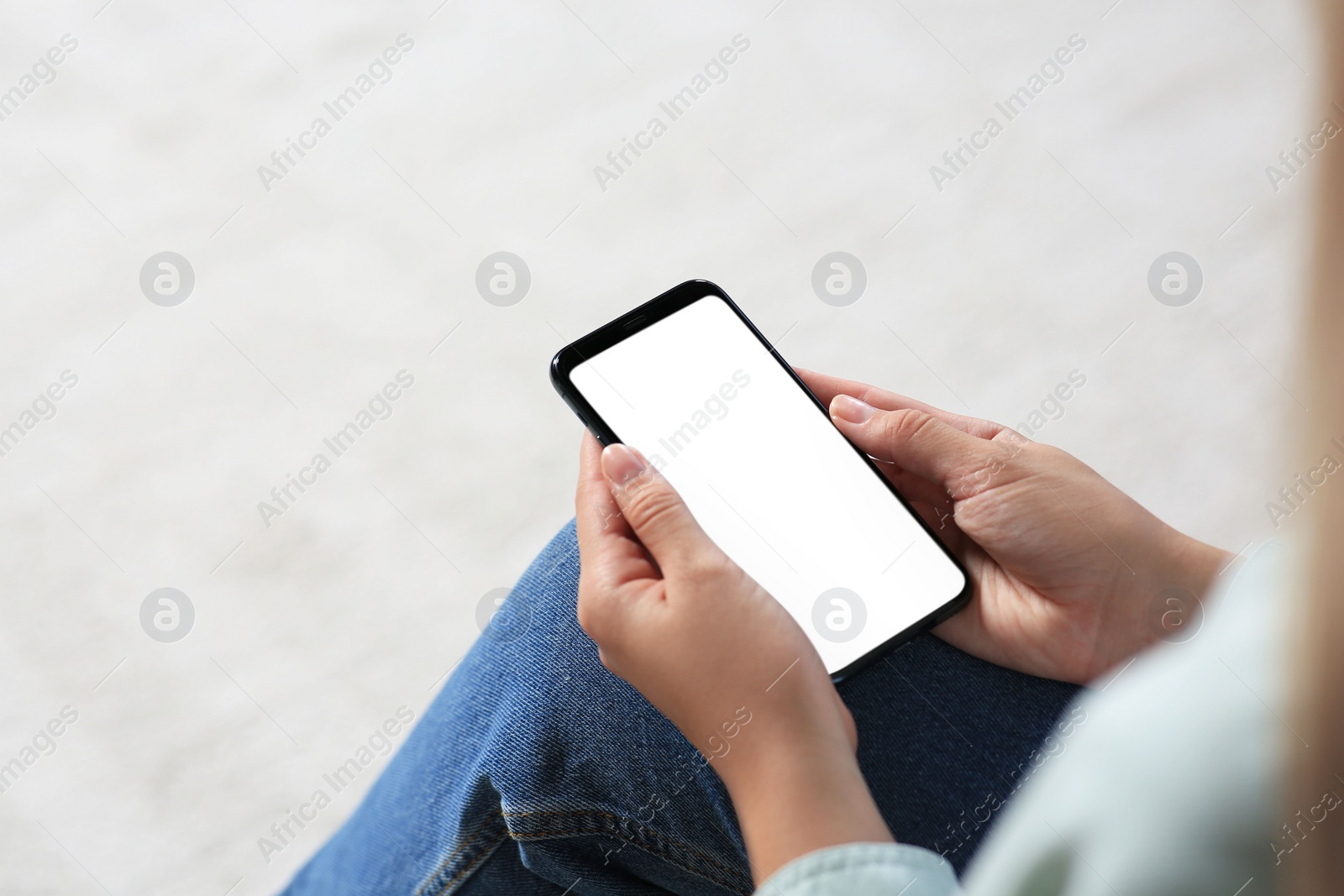 Photo of Closeup view of woman with smartphone indoors. Space for text