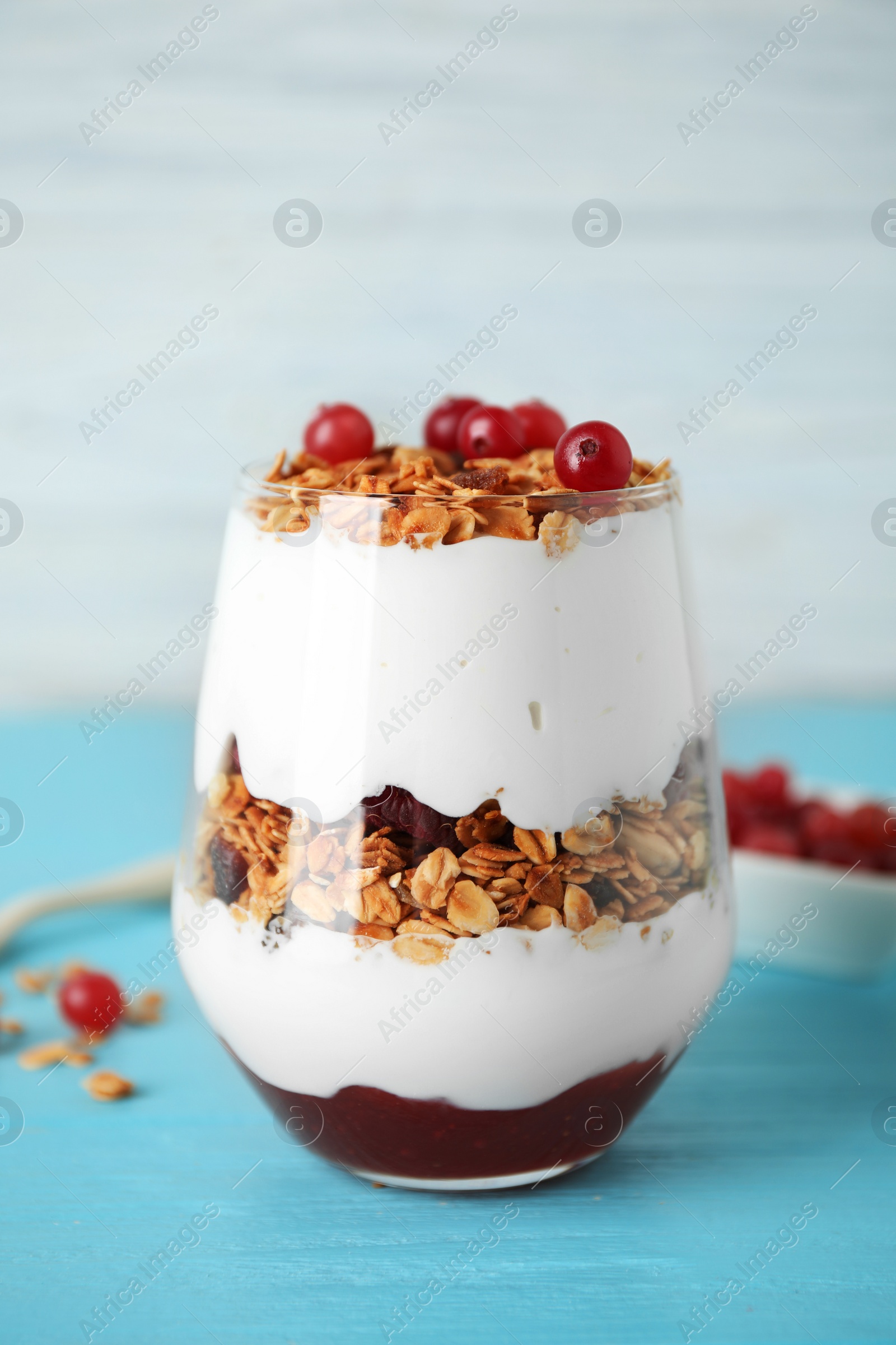 Photo of Tasty homemade granola served on blue wooden table. Healthy breakfast