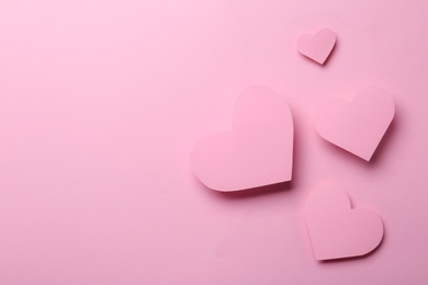 Photo of Paper hearts on pink background, flat lay. Space for text