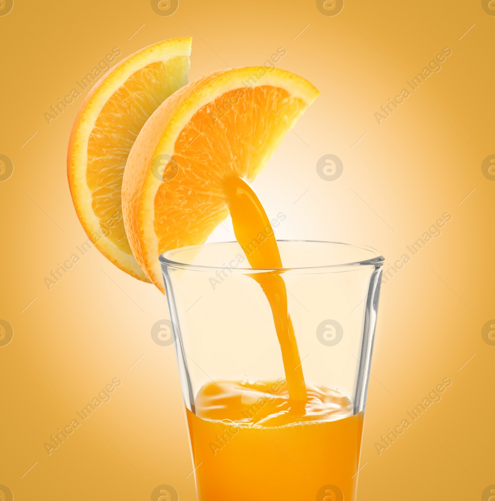 Image of Making orange fresh. Juice pouring from orange citrus slices into glass on golden background