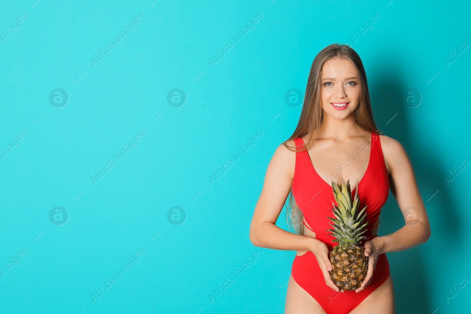 Photo of Beautiful woman with pineapple wearing bikini on color background