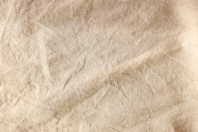 Photo of Beautiful beige fabric as background, top view