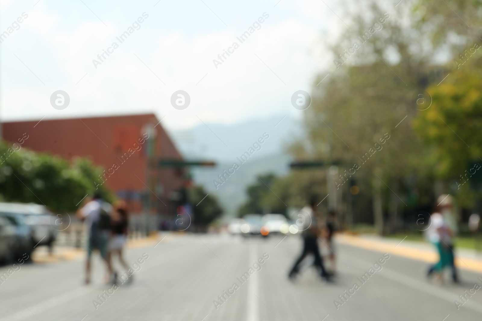 Photo of Blurred view of people crossing city street