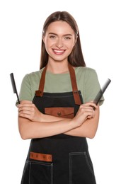 Portrait of happy hairdresser with combs on white background