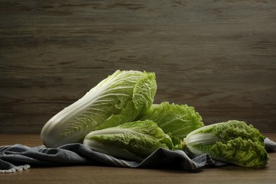 Photo of Fresh ripe Chinese cabbages on wooden table