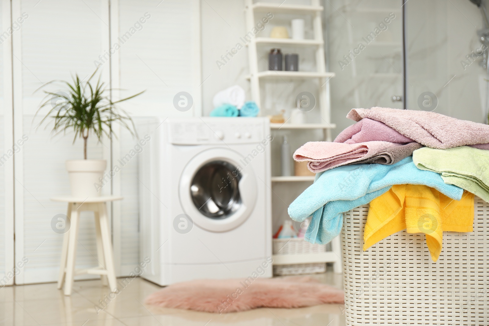 Photo of Basket with laundry in bathroom. Space for text