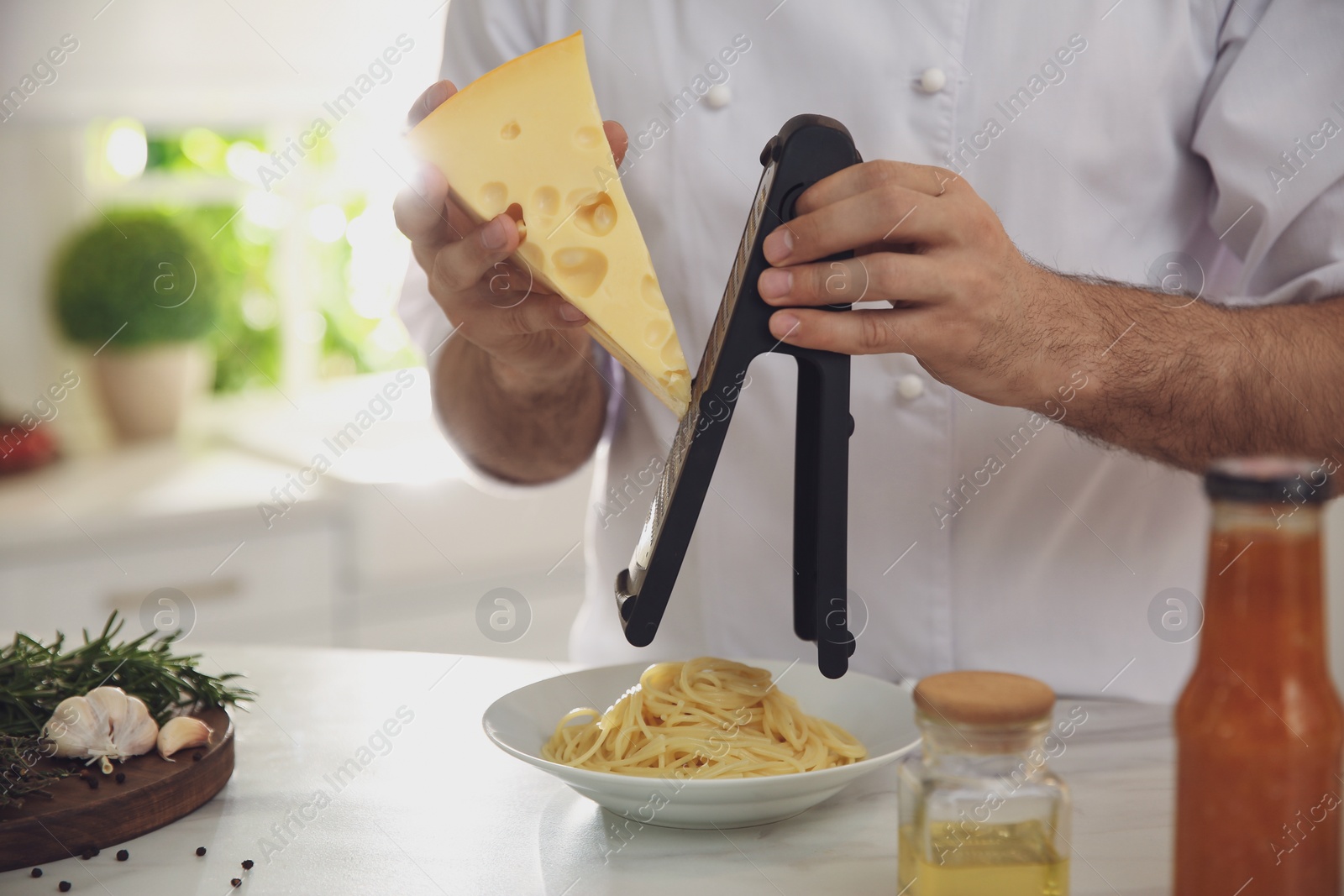 Photo of Chef cooking at table in kitchen, closeup