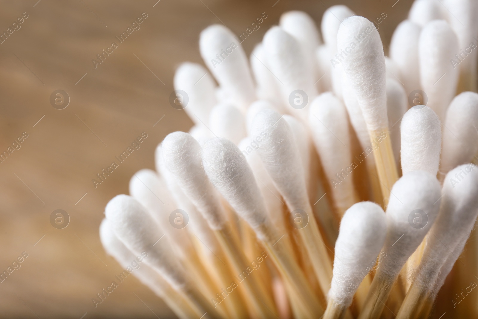 Photo of Many cotton buds on blurred background, closeup