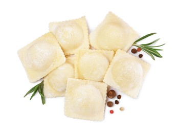 Photo of Uncooked ravioli, rosemary and peppercorns on white background, top view
