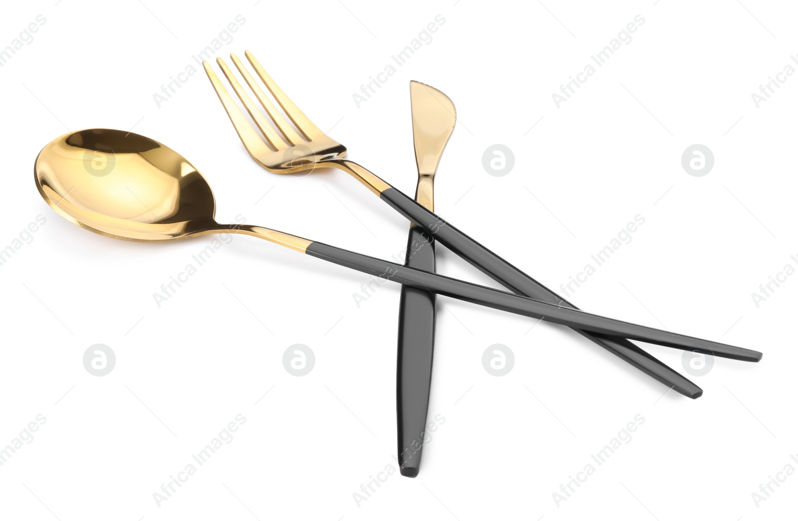 Photo of Shiny golden fork, knife and spoon isolated on white. Luxury cutlery set