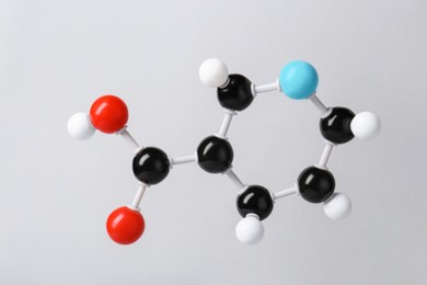 Photo of Molecule of vitamin B3 on light grey background. Chemical model